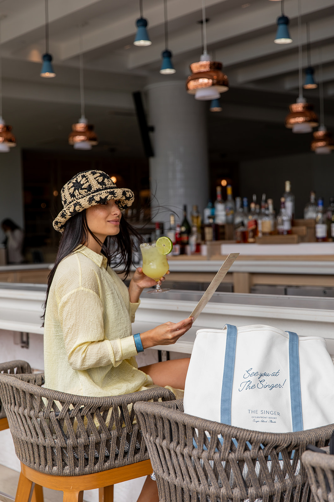 woman enjoying a drink at caretta caretta inside the singer resort