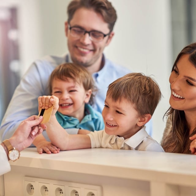 Picture of happy family checking in a hotel