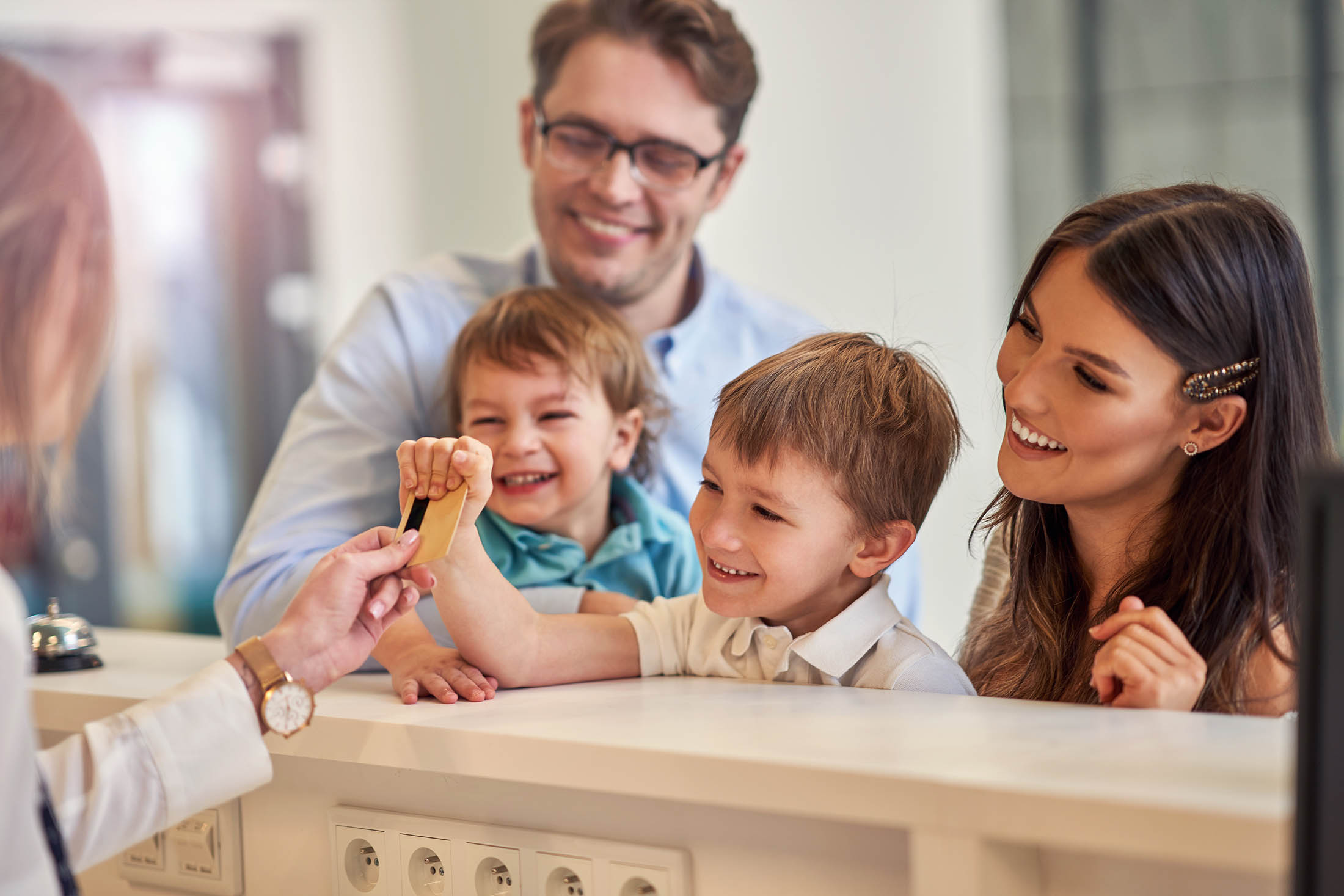 Picture of happy family checking in a hotel