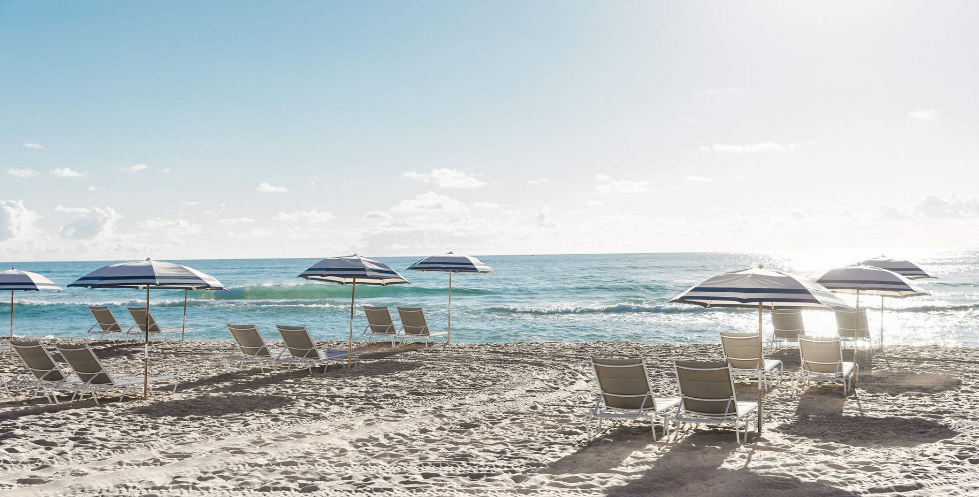 white umbrellas at the singer oceanfront resort west palm beach