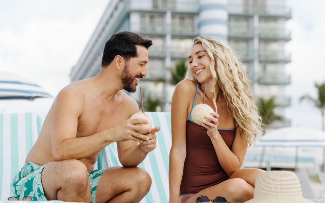 couple enjoying coconut water at the singer oceanfront resort