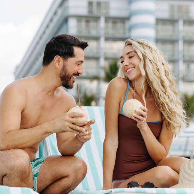 couple enjoying coconut water at the singer oceanfront resort