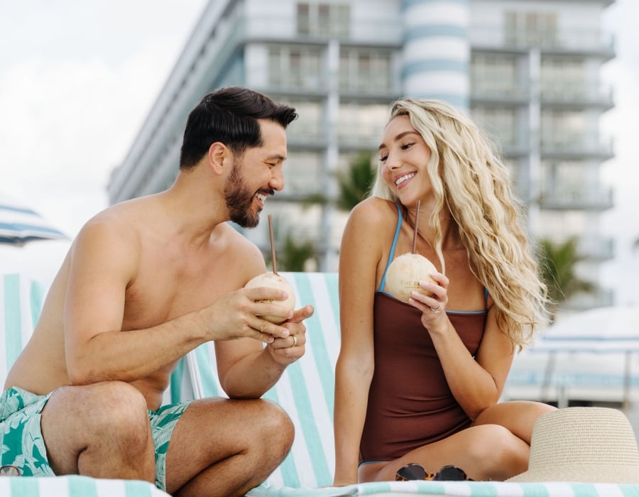 couple enjoying coconut water at the singer oceanfront resort