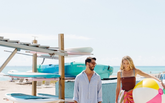 couple posing with kayaks on singer island