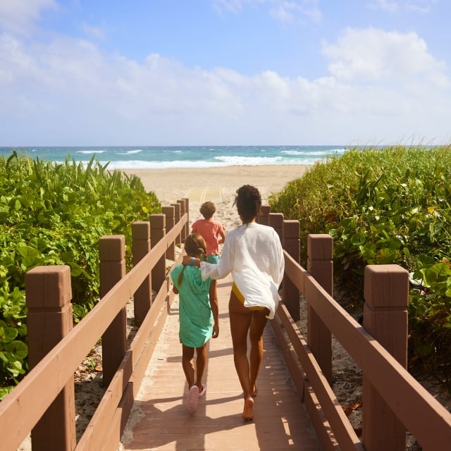 family walking towards the beach on singer island