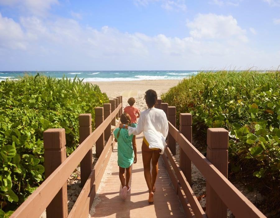 family walking towards the beach on singer island