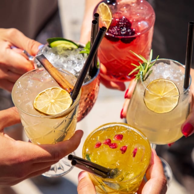 People celebrating and toasting with elegant cocktails