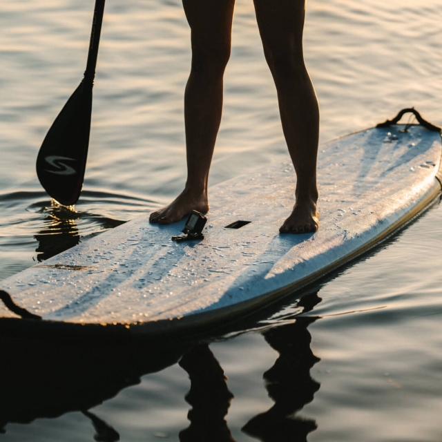 Person paddle boarding on the ocean
