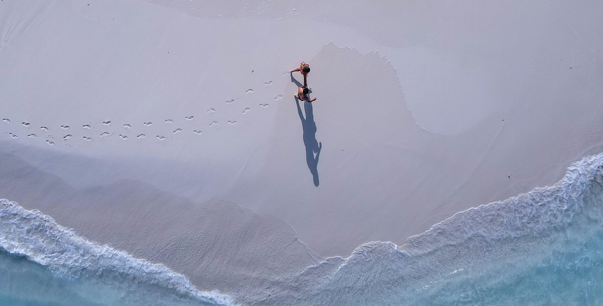Aerial image of a person walking on the beach