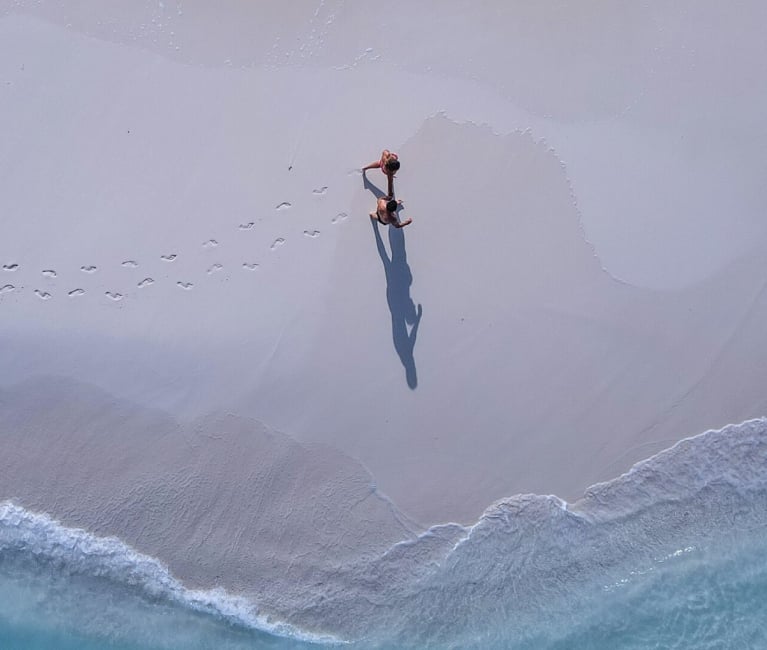 Aerial image of a person walking on the beach