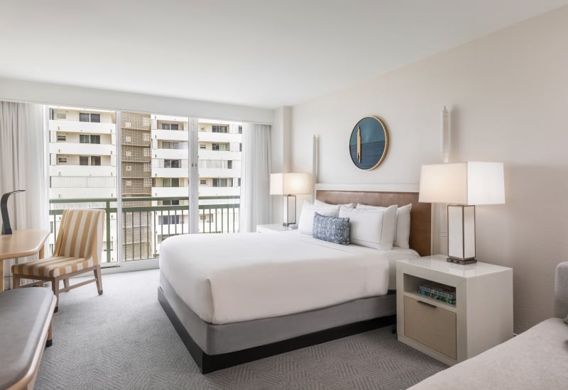 Spacious guest room with panoramic views and elegant decor at West Palm Beach Hotel.