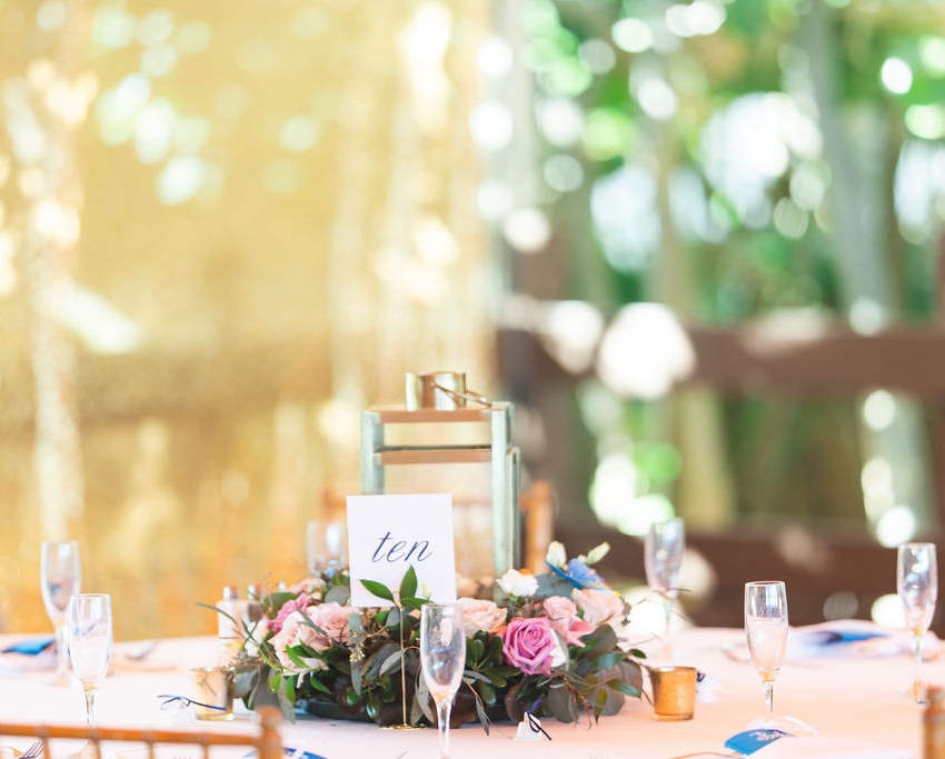 Elegant floral wedding decoration table with champaign glasses at The Singer Oceanfront Resort